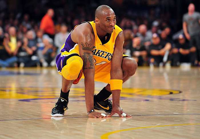 Los Angeles Lakers shooting guard Kobe Bryant squats down during a game.